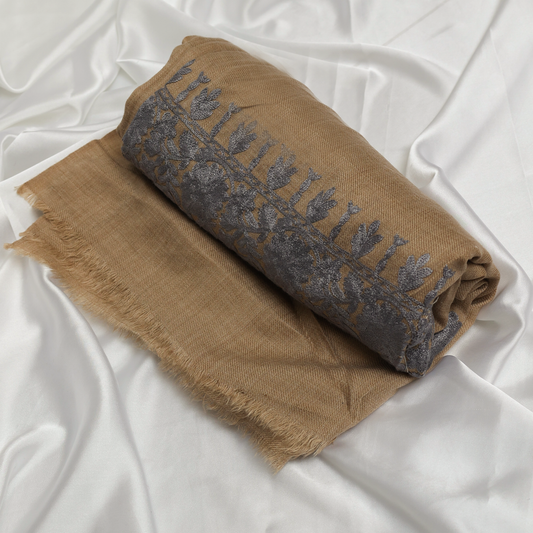 Woman wearing a beige and brown patterned Embroidered Shawl