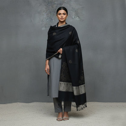 Woman wearing a black and gray patterned Shawl 