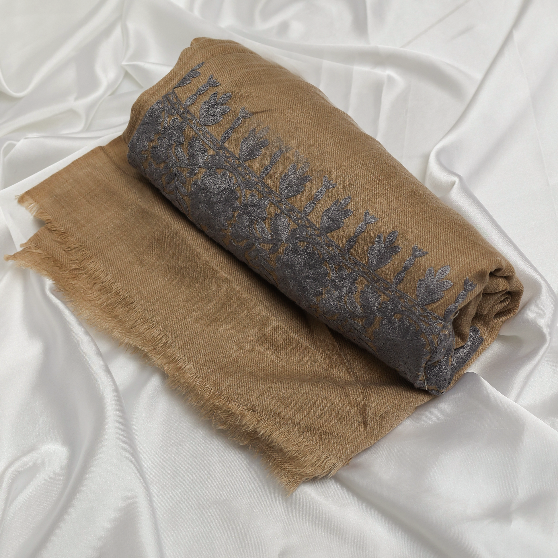 Woman wearing a beige and brown patterned Embroidered Shawl 