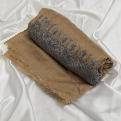 Woman wearing a beige and brown patterned Embroidered Shawl 
