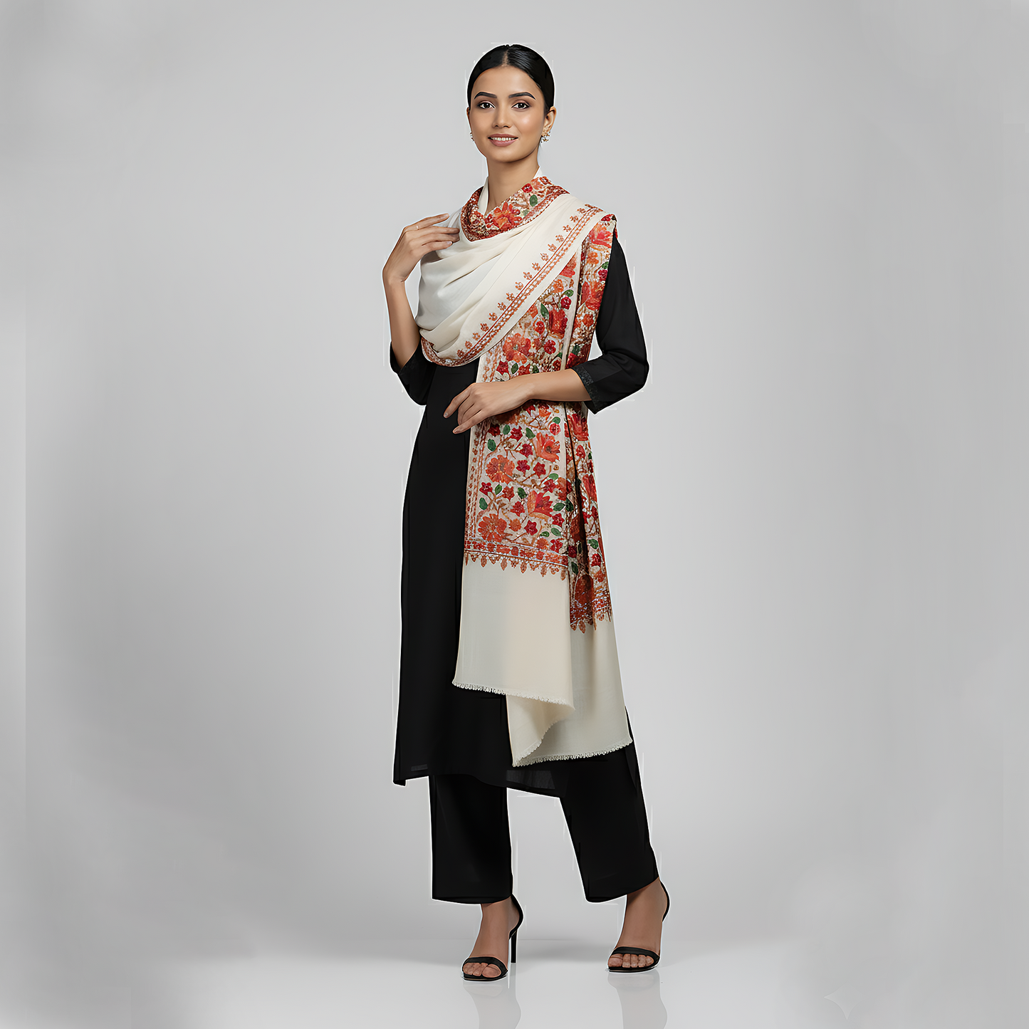 Woman wearing a black and white outfit with a floral woolen shawl 